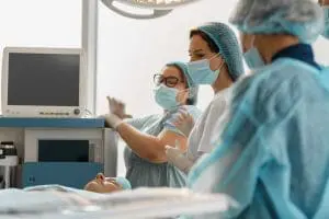 a surgical team working in an operating room which emphasizes the importance of medical billing for surgery centers