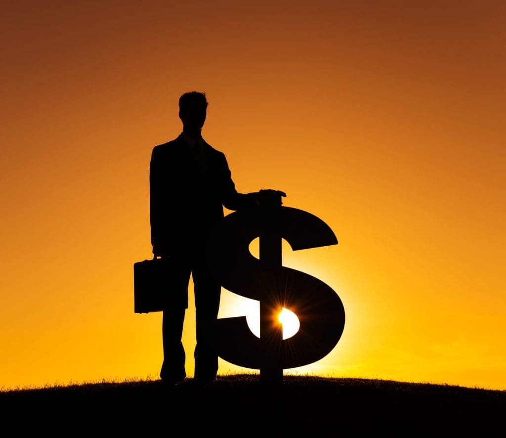 silhouette of a man standing with a giant dollar sign at sunset to show the importance of forensic collection