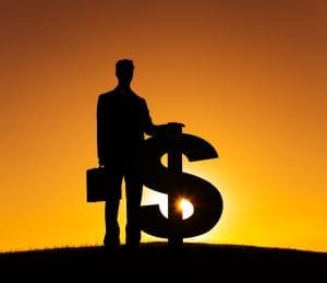 silhouette of a man standing with a giant dollar sign at sunset to show the importance of forensic collection