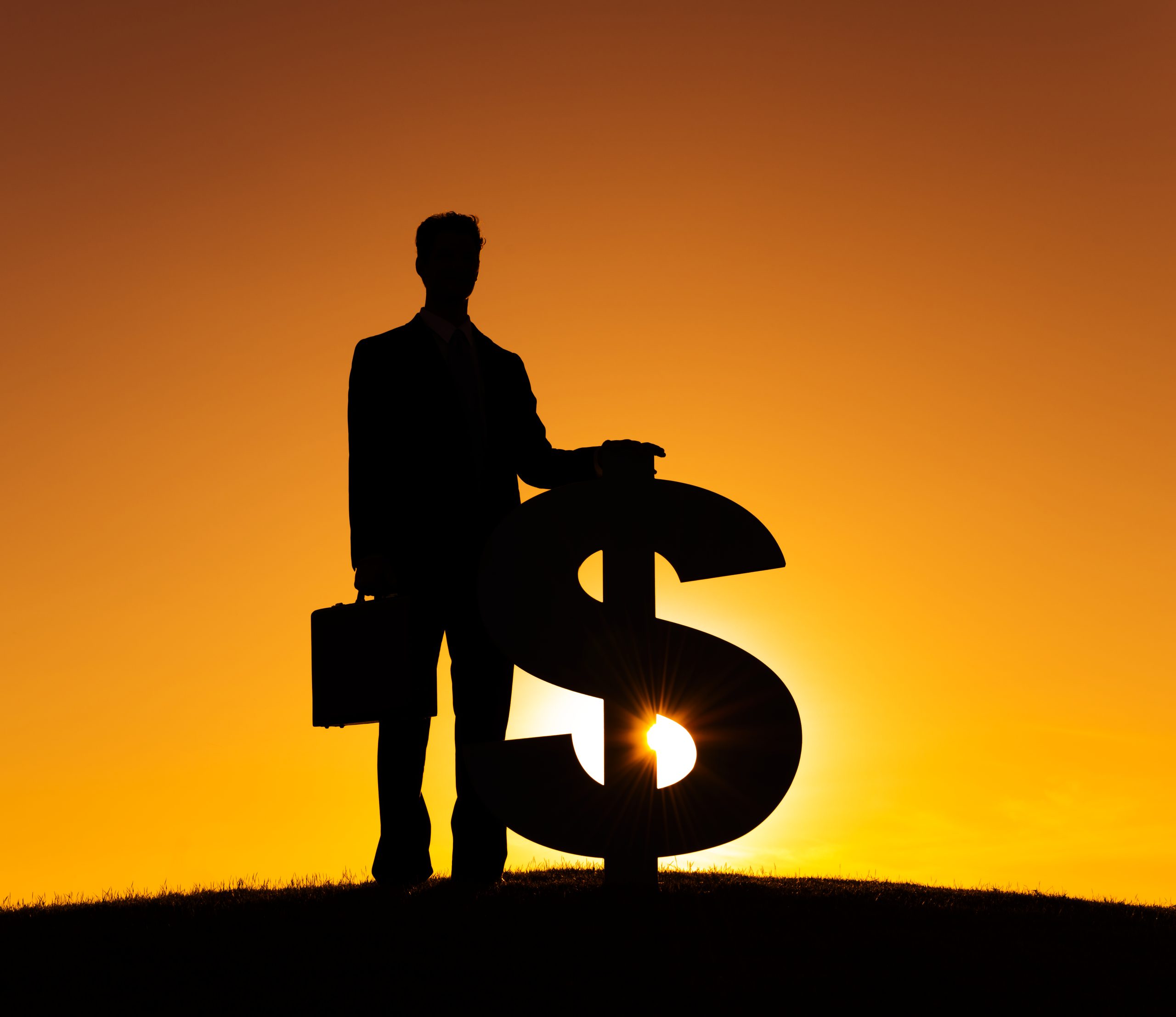 silhouette of a man standing with a giant dollar sign at sunset to show the importance of forensic collection
